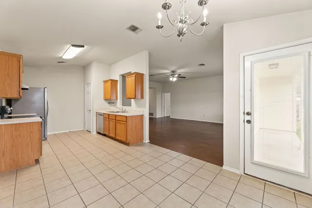 a kitchen with stainless steel appliances a refrigerator and a stove top oven
