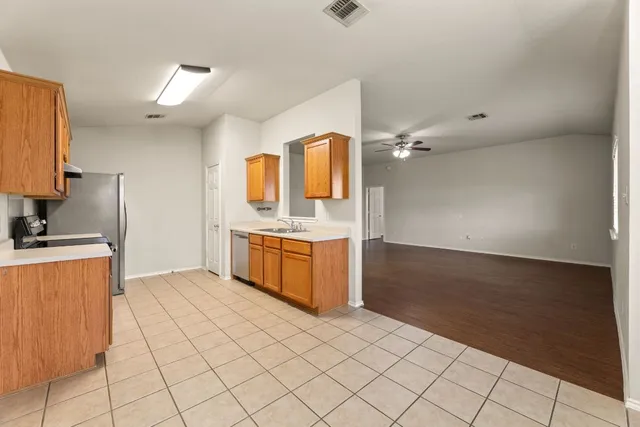a kitchen with stainless steel appliances a sink and a stove top oven