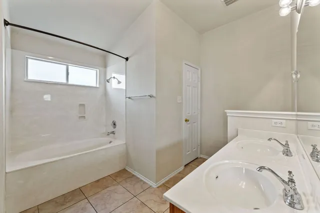 a bathroom with a bathtub and a shower