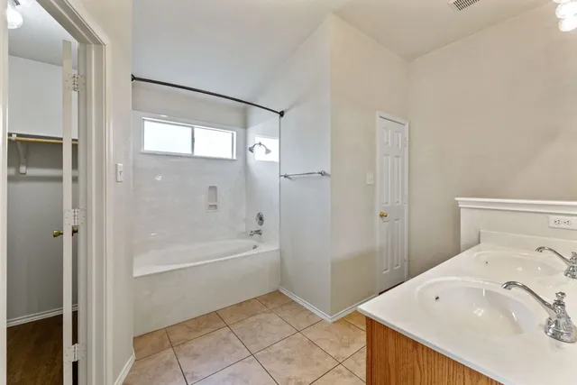 a bathroom with a bathtub and a sink