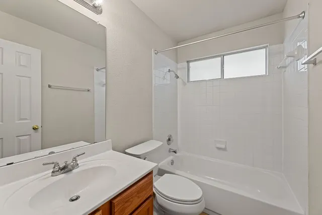 a bathroom with a sink mirror toilet and bathtub