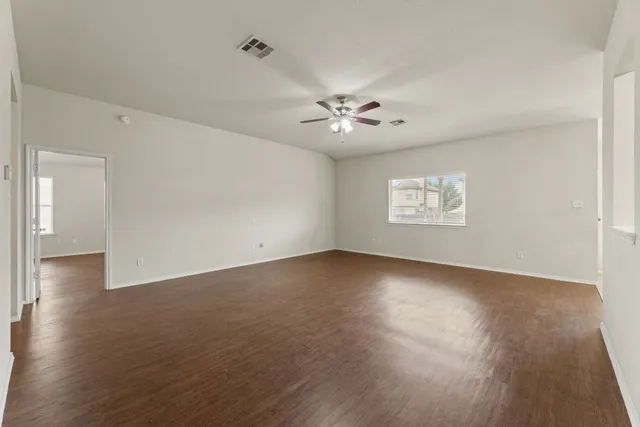 wooden floor in an empty room with a window