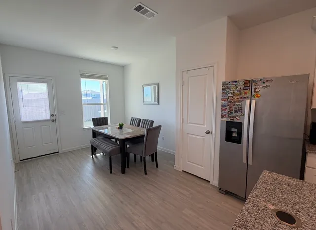 a view of a dining room with furniture and window