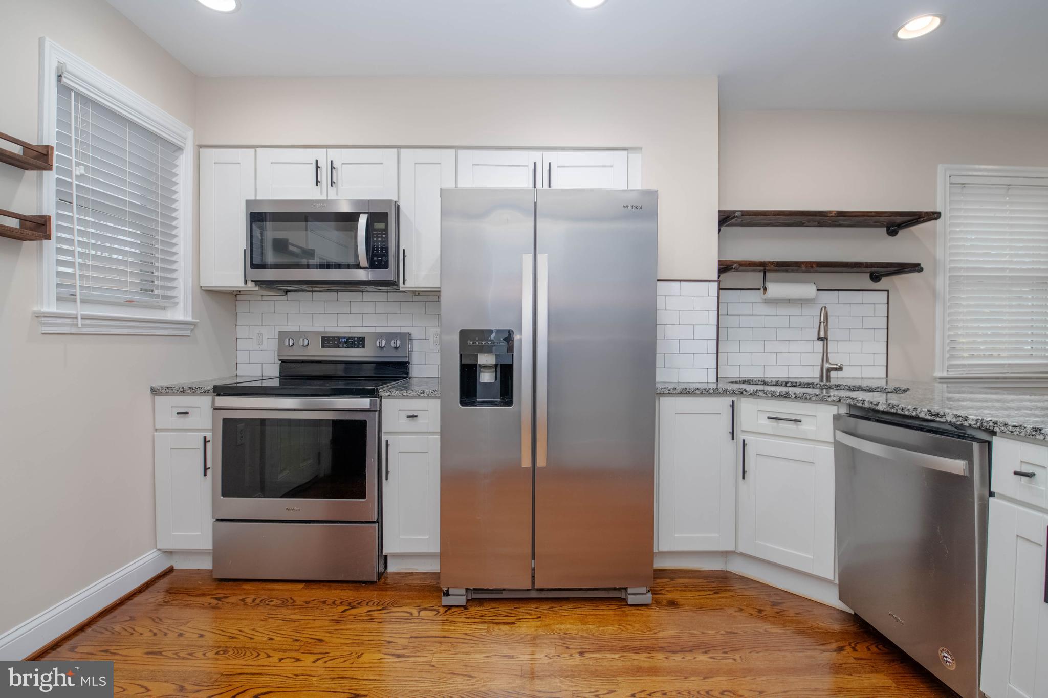 3004 Dunmurry Road Dundalk, MD 21222 - Photo 13 of 40 a kitchen with stainless steel appliances granite countertop a refrigerator stove and sink