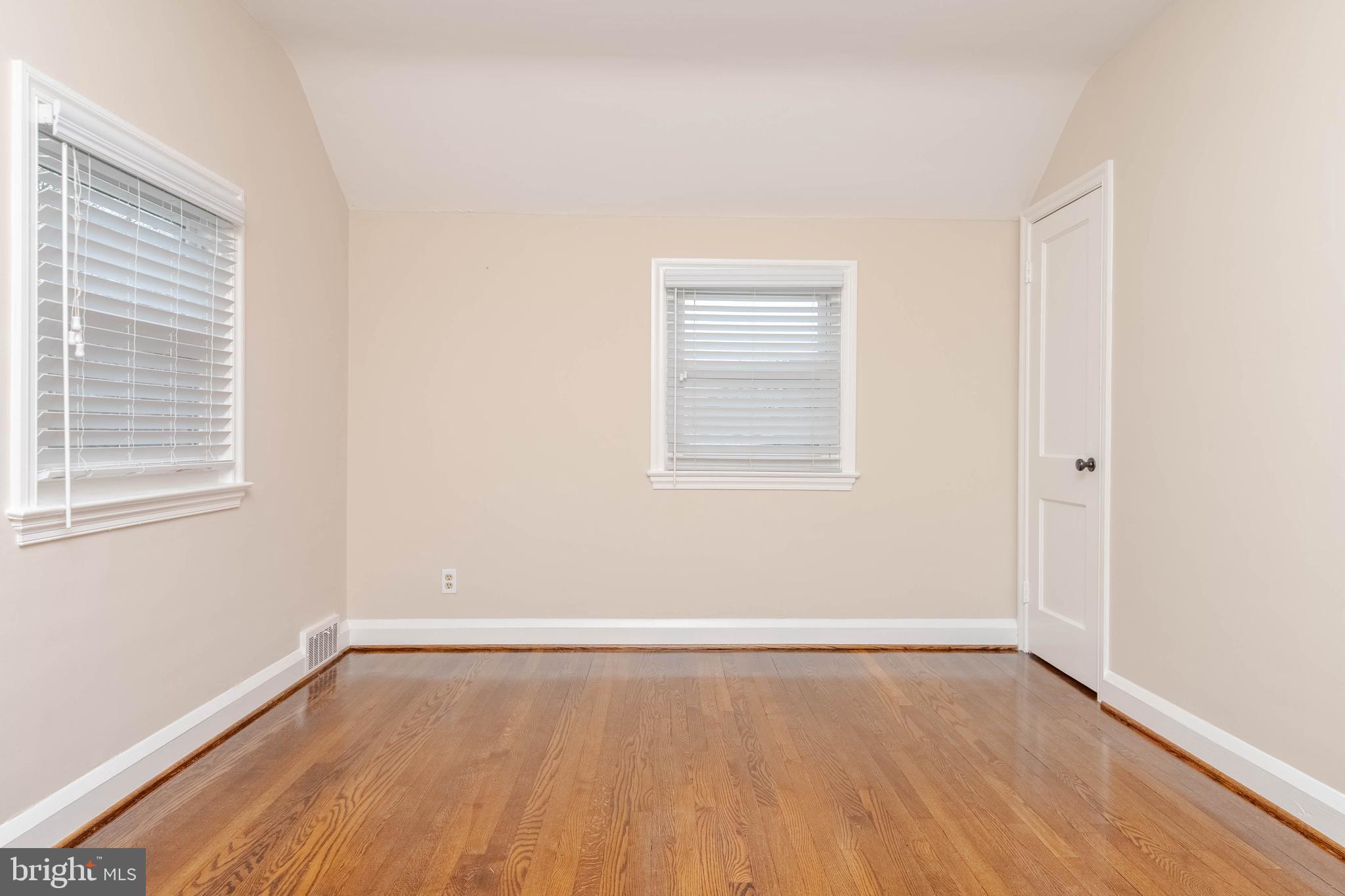 3004 Dunmurry Road Dundalk, MD 21222 - Photo 17 of 40 an empty room with wooden floor and windows