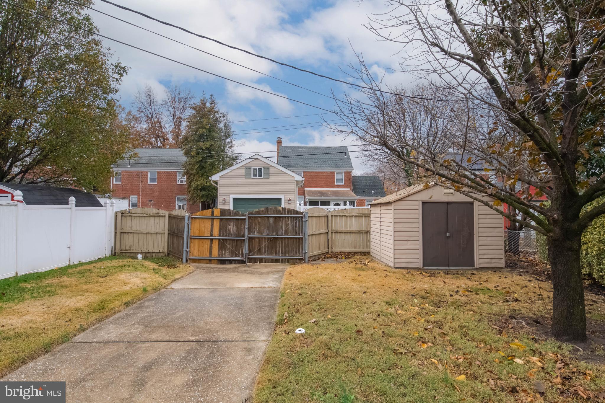 3004 Dunmurry Road Dundalk, MD 21222 - Photo 37 of 40 a view of a house with a large tree and wooden fence