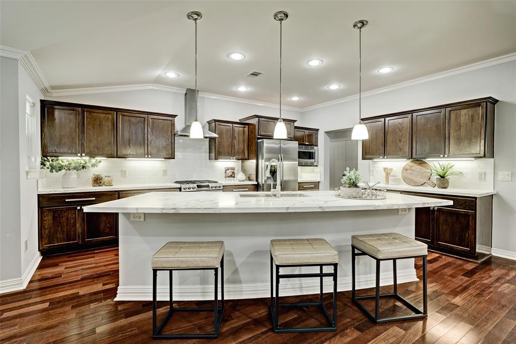 a kitchen with kitchen island granite countertop a sink and counter space