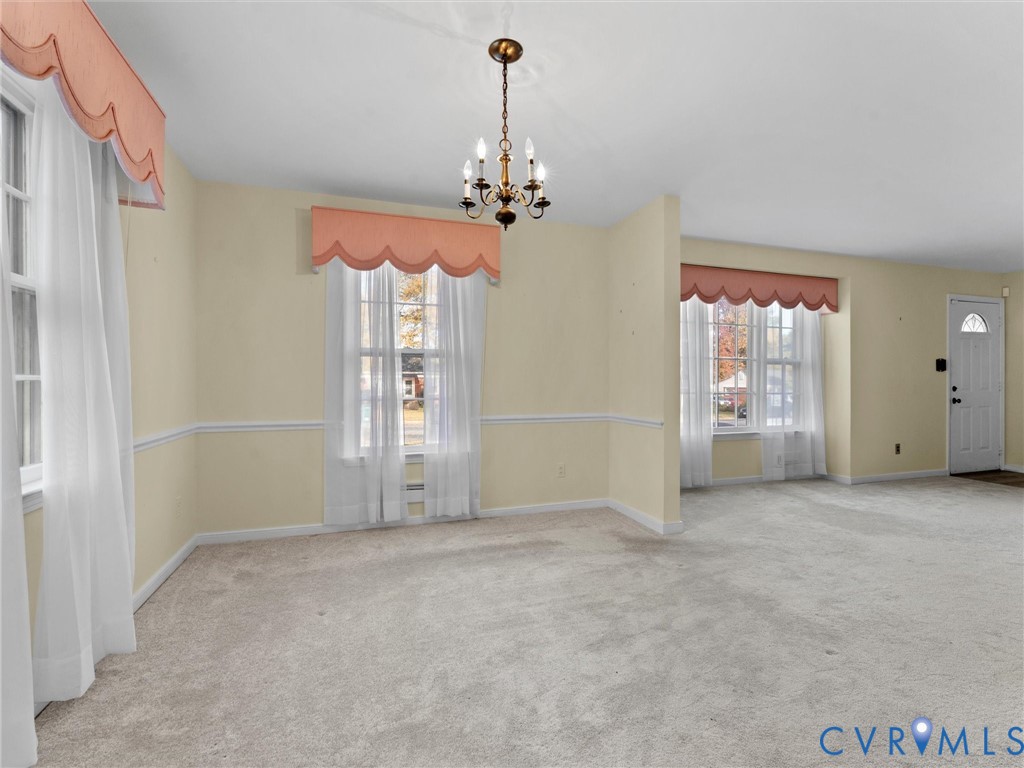 1803 Windsordale Drive Henrico, VA 23229 - Photo 11 of 46 Unfurnished dining area with carpet and a chandeli