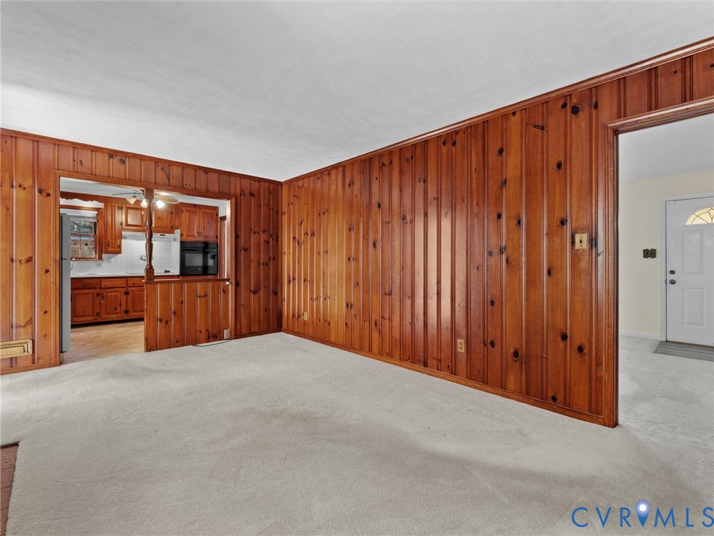 1803 Windsordale Drive Henrico, VA 23229 - Photo 23 of 46 Unfurnished living room with wood walls and light