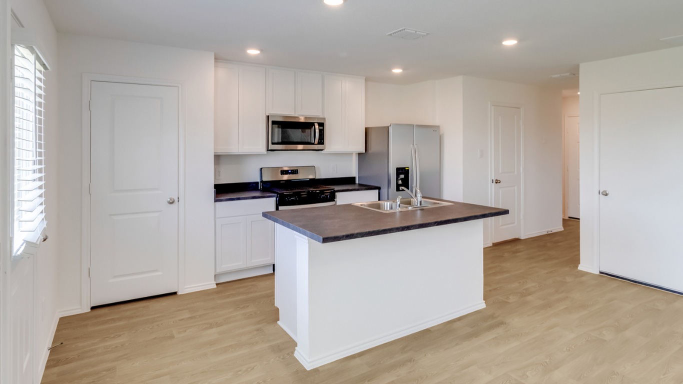845 Arnold Loop Kyle, TX 78640 - Photo 6 of 17 a kitchen with stainless steel appliances a sink stove and refrigerator