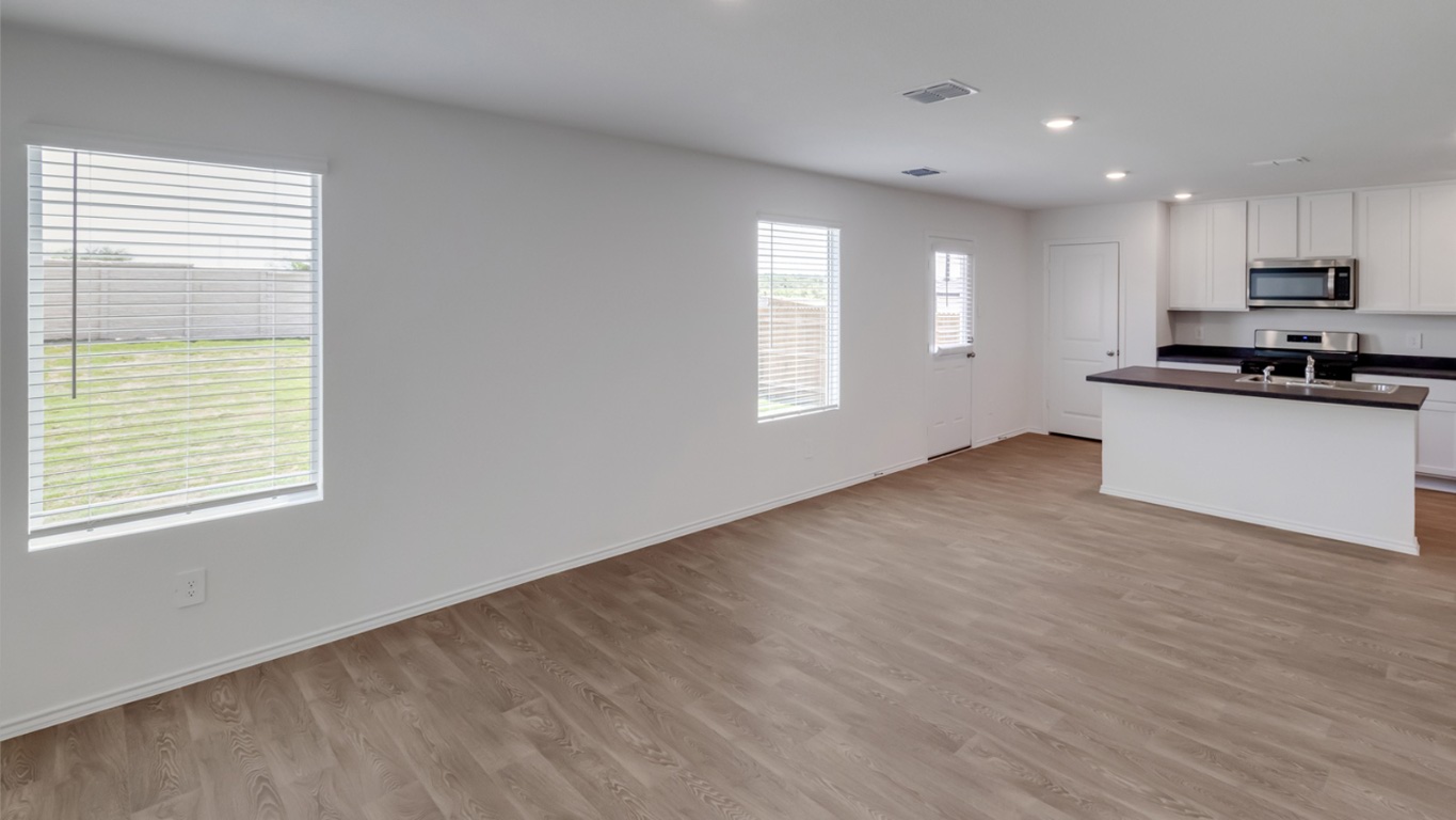 845 Arnold Loop Kyle, TX 78640 - Photo 9 of 17 a view of kitchen with sink and wooden floor