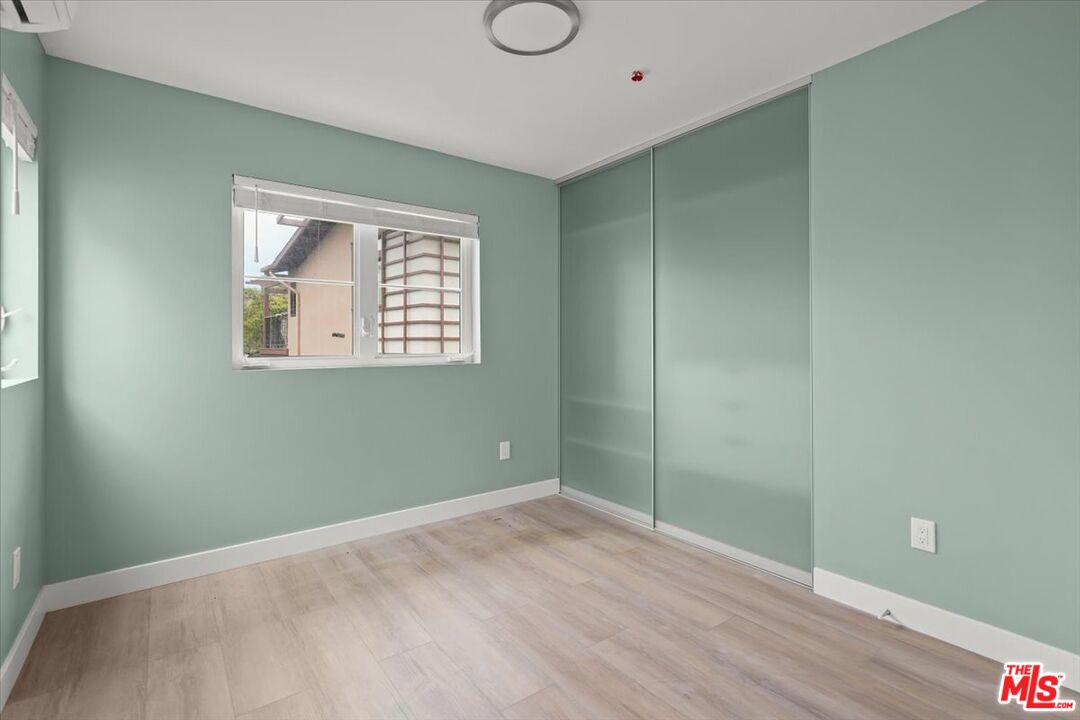 1317 Punta Gorda Street, Unit 4 Santa Barbara, CA 93103 - Photo 19 of 70 a view of an empty room with wooden floor and a window
