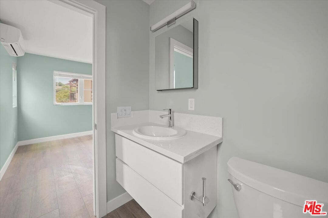 1317 Punta Gorda Street, Unit 4 Santa Barbara, CA 93103 - Photo 25 of 70 a bathroom with a sink toilet and vanity