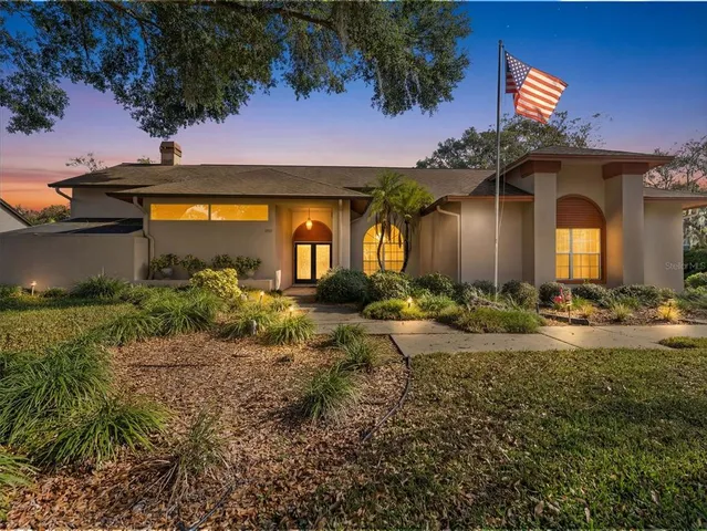 a front view of house with yard and outdoor seating