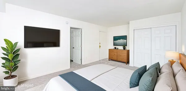 a bedroom with a bed and a television