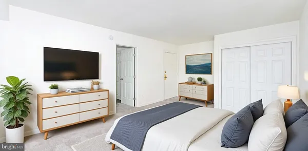 a bedroom with furniture and a flat screen tv