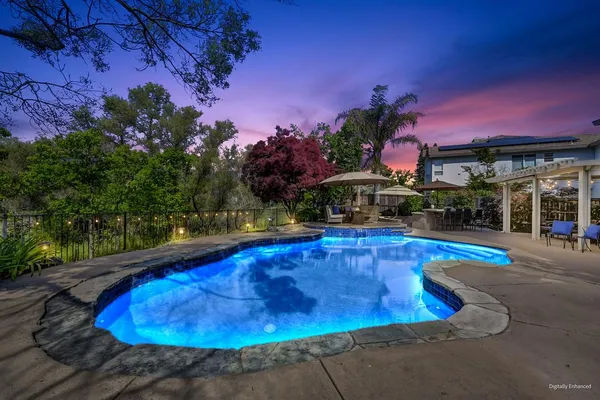 a view of a swimming pool with an outdoor space and seating area