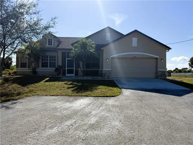 a view of a house with a yard and garage
