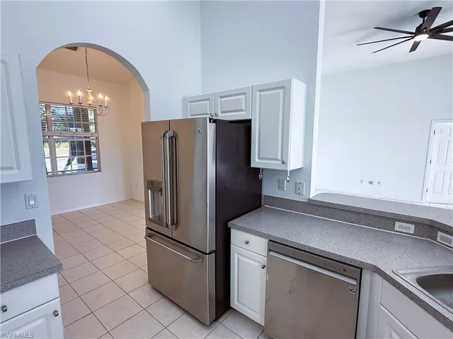 a kitchen with a refrigerator and cabinets