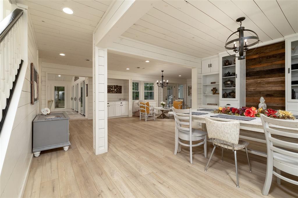 8948 David Fort Road Argyle, TX 76226 - Photo 9 of 39 Spacious interior featuring light wood-finish flooring, white shiplap walls and ceiling, recessed lighting, and a white staircase with a dark wood handrail