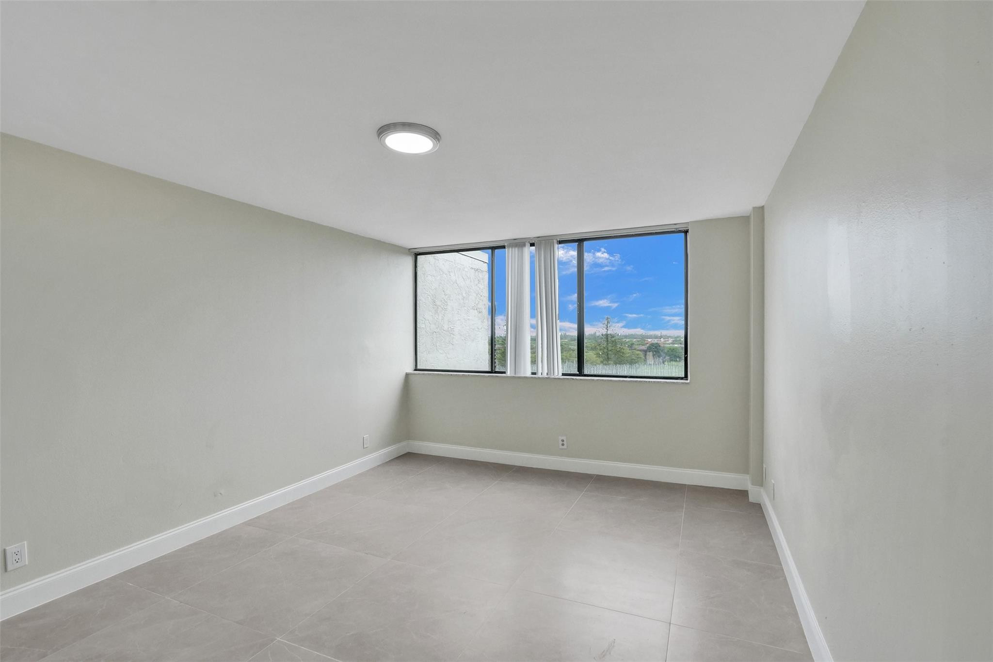 4222 Inverrary Boulevard, Unit 4810 Lauderhill, FL 33319 - Photo 43 of 63 a view of an empty room with a window