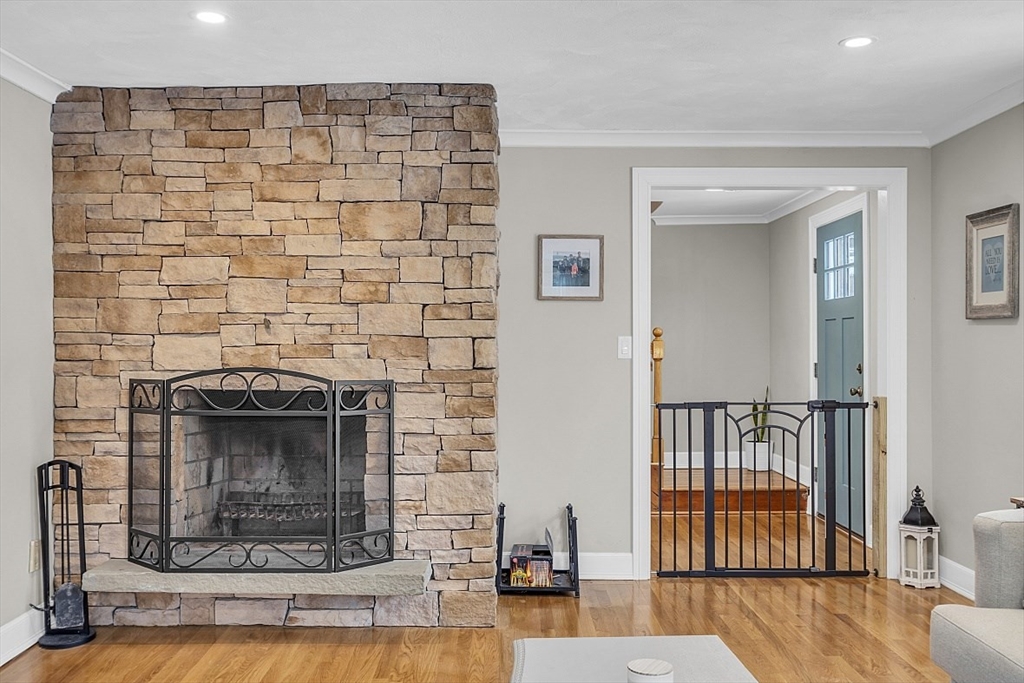 2 Greenbriar Circle Andover, MA 01810 - Photo 16 of 41 a living room with a fireplace and wooden floor