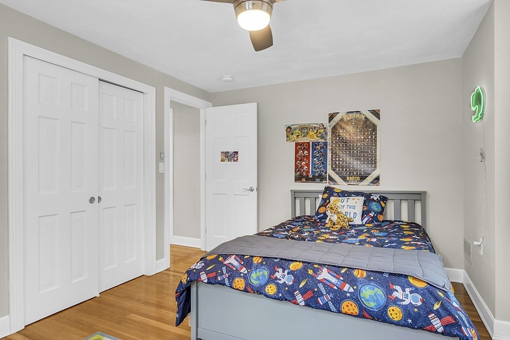 2 Greenbriar Circle Andover, MA 01810 - Photo 28 of 41 a bedroom with a bed and a chandelier