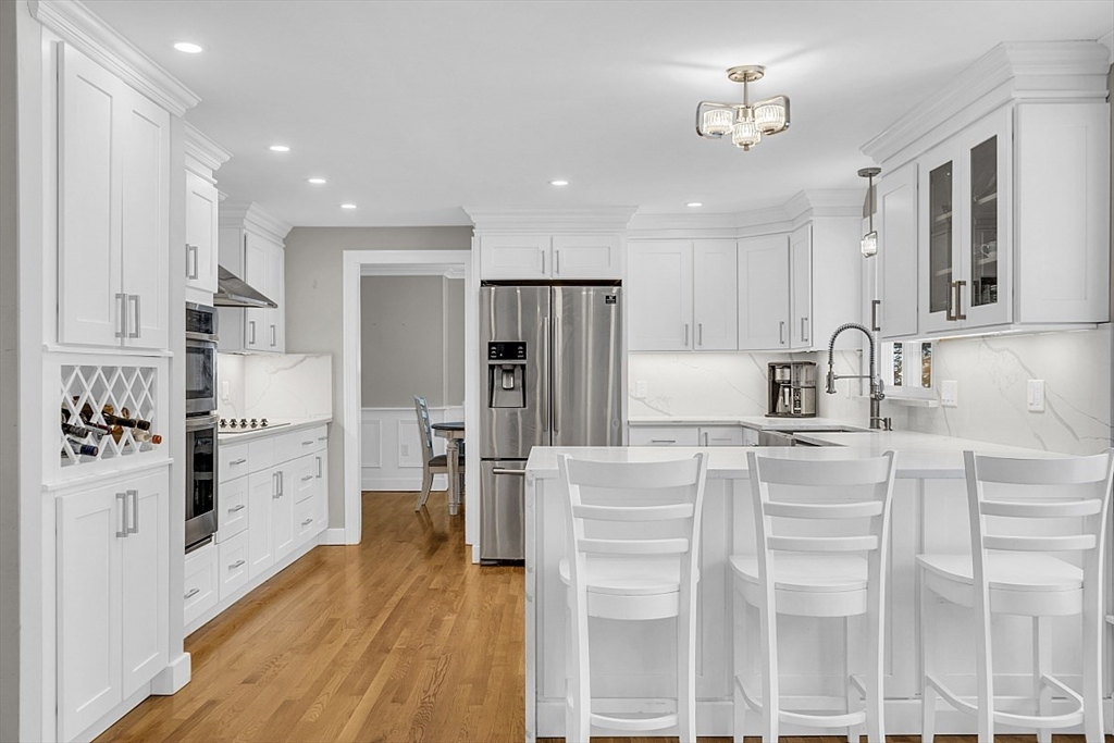 2 Greenbriar Circle Andover, MA 01810 - Photo 7 of 41 a kitchen with white cabinets and stainless steel appliances