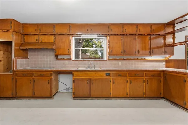 a kitchen with stainless steel appliances granite countertop a sink and a cabinets