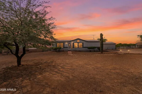 a view of house with yard and lake view