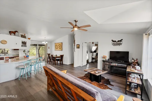 a living room with furniture a flat screen tv and a large window