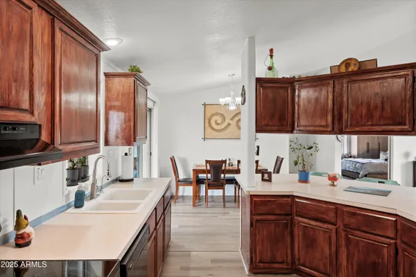 a kitchen with a sink cabinets and wooden floor