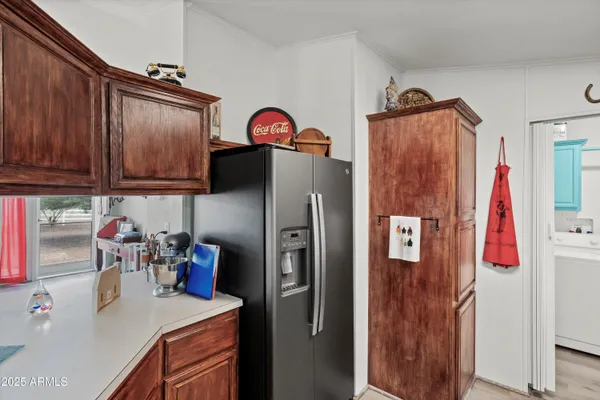 a kitchen with refrigerator and sink