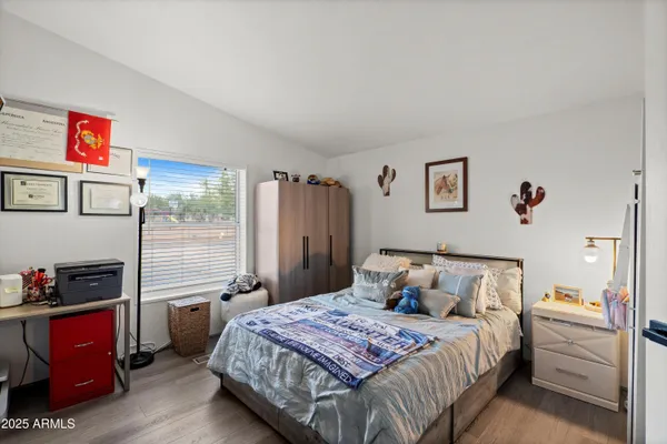 an empty room with closet and a window