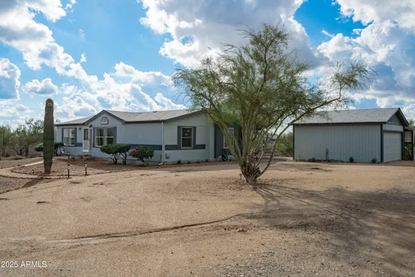 a view of a house with a backyard porch and garden