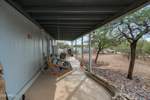 a backyard of a house with table and chairs