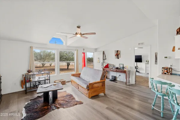 a living room with furniture and a wooden floor