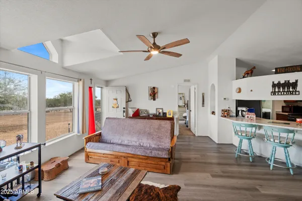 a living room with furniture a rug and a chandelier