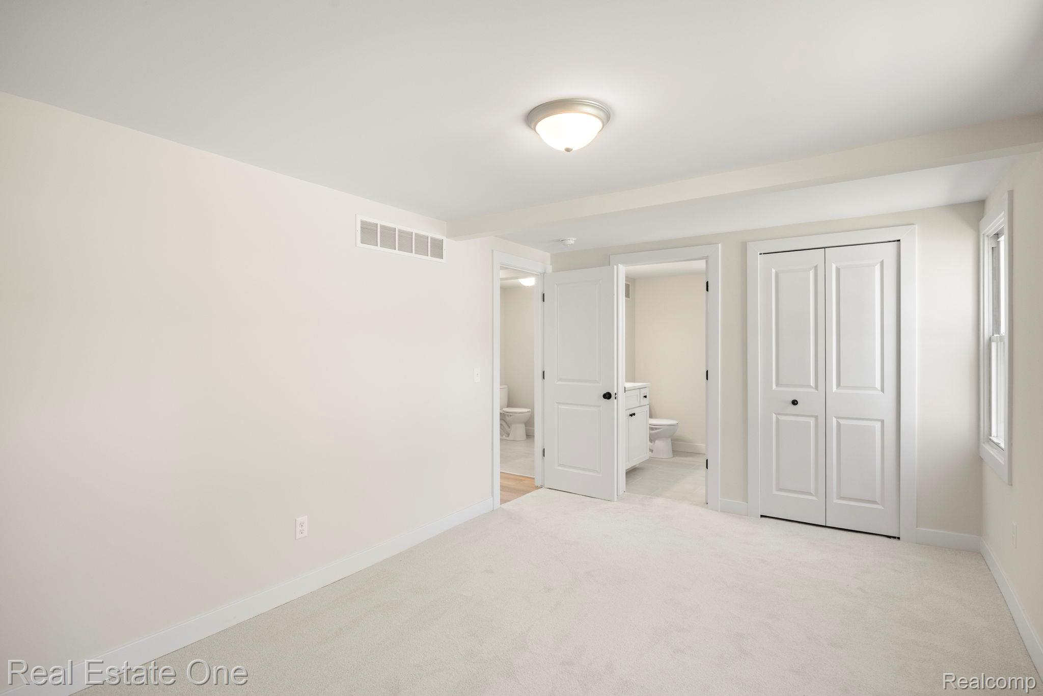 3200 Hessel Avenue Rochester, MI 48307 - Photo 12 of 32 Unfurnished bedroom with light carpet, a closet, and ensuite bath