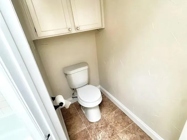 a white toilet sitting next to a sink