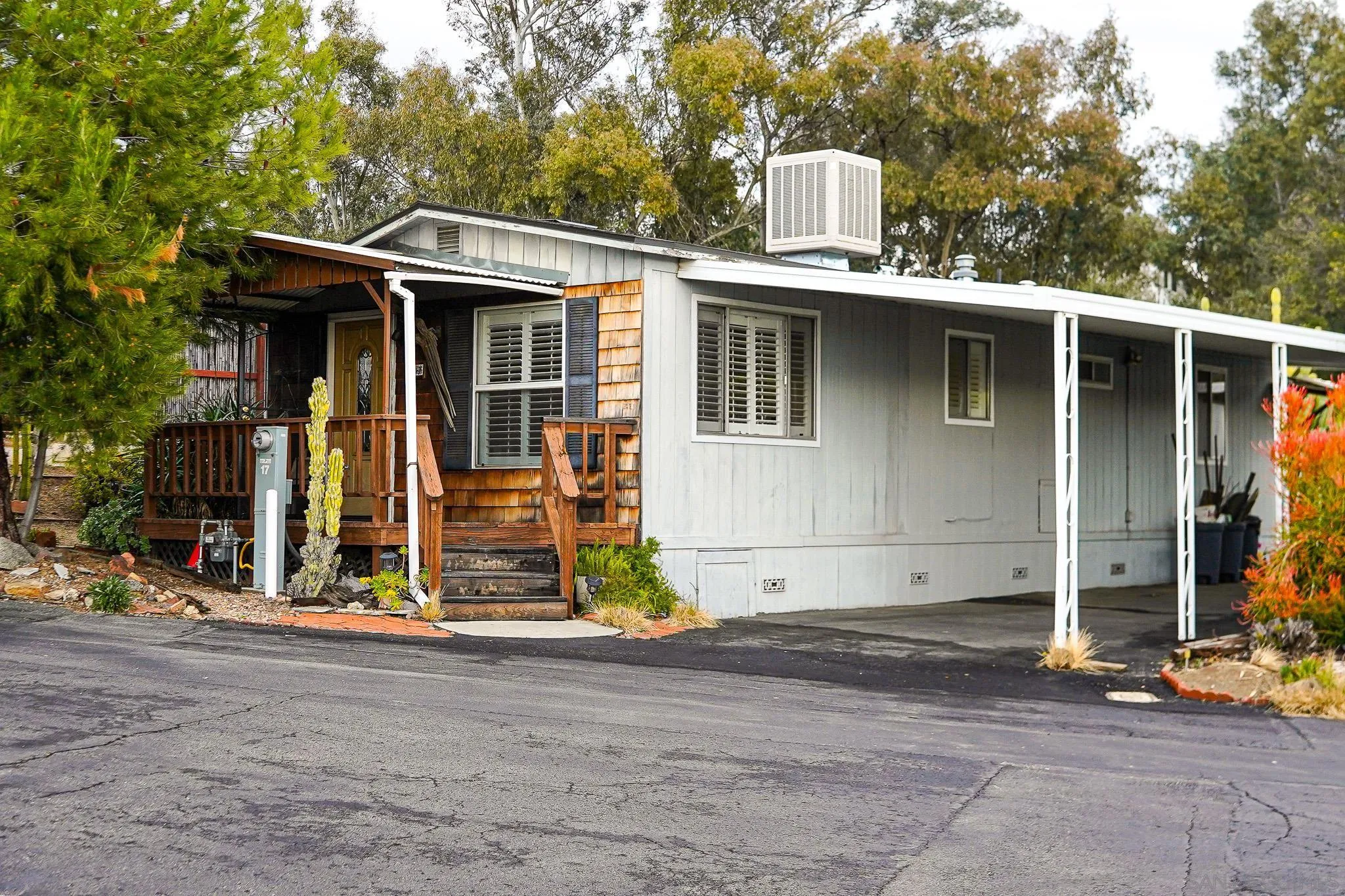 a view of a house with tub and trees in the background