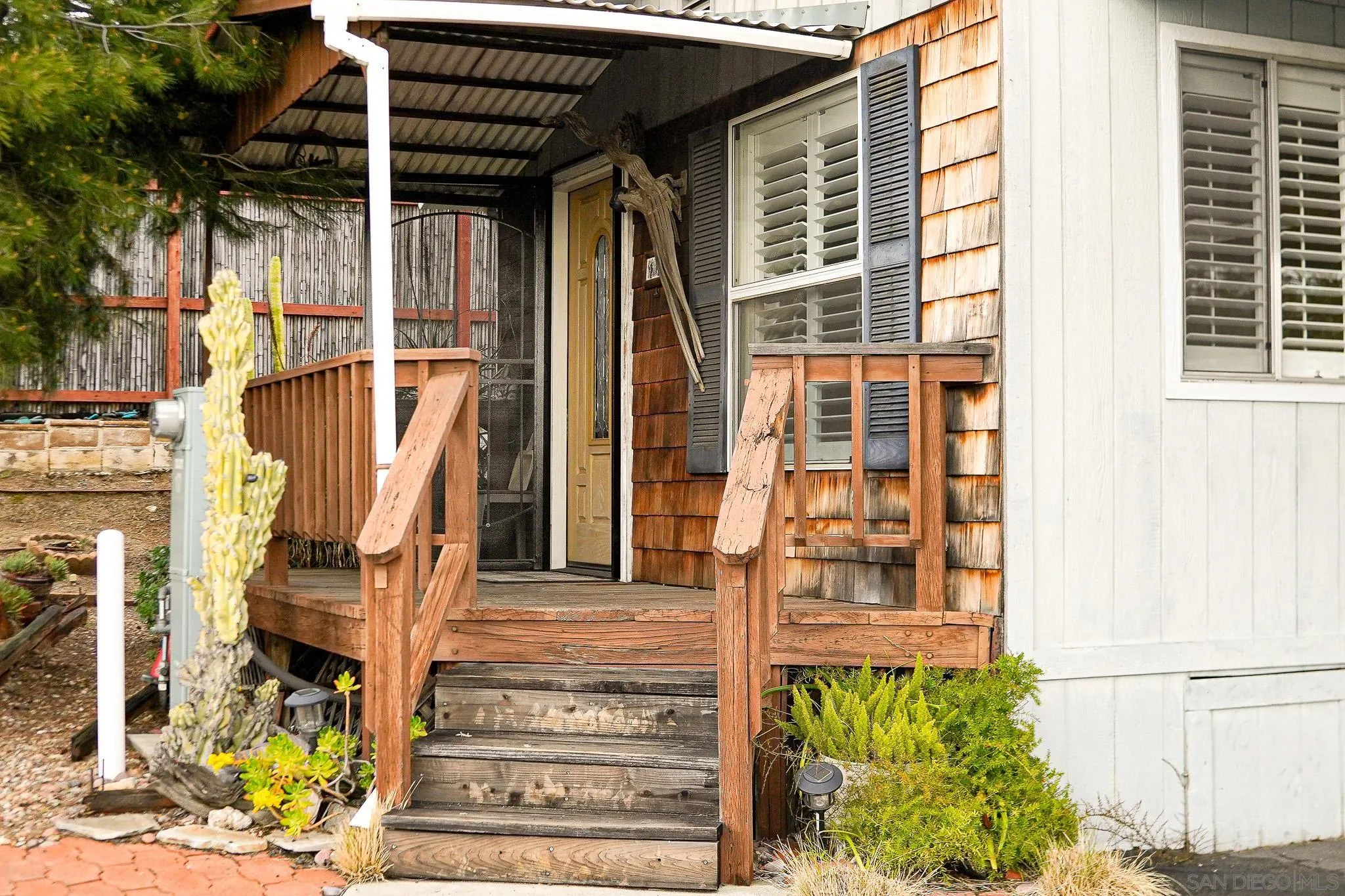 2400 Alpine Boulevard, Unit 17 Alpine, CA 91901 - Photo 2 of 22 a front view of a building with a garden