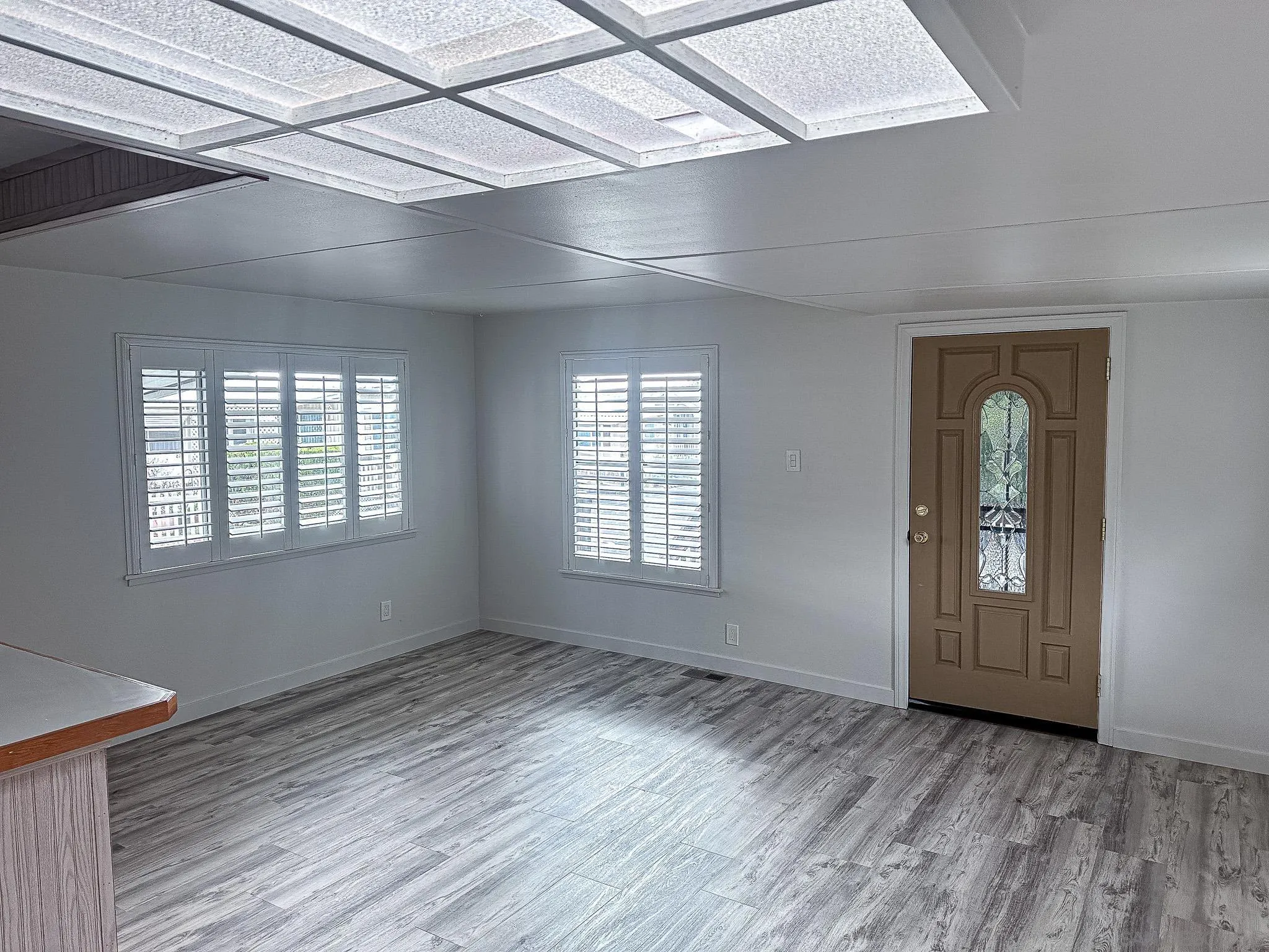 2400 Alpine Boulevard, Unit 17 Alpine, CA 91901 - Photo 4 of 22 an empty room with wooden floor and windows