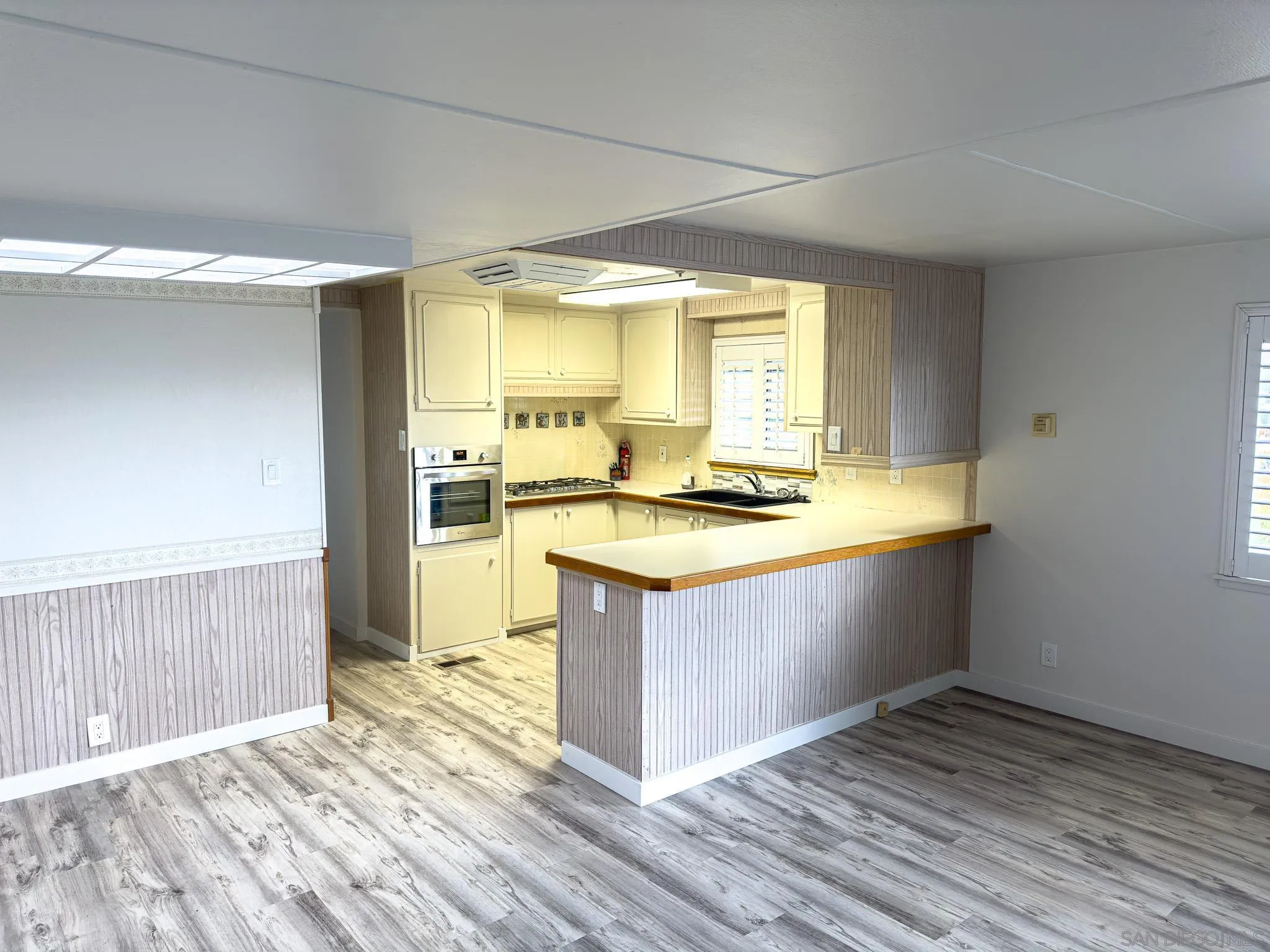 2400 Alpine Boulevard, Unit 17 Alpine, CA 91901 - Photo 6 of 22 a kitchen with stainless steel appliances granite countertop a sink stove and wooden floor