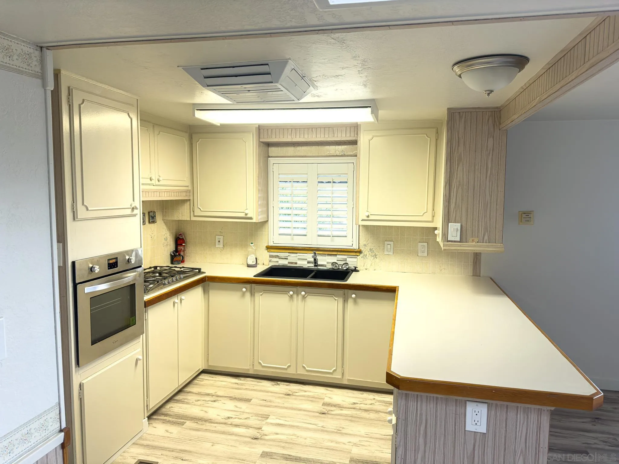 2400 Alpine Boulevard, Unit 17 Alpine, CA 91901 - Photo 7 of 22 a kitchen with stainless steel appliances granite countertop a sink stove and refrigerator