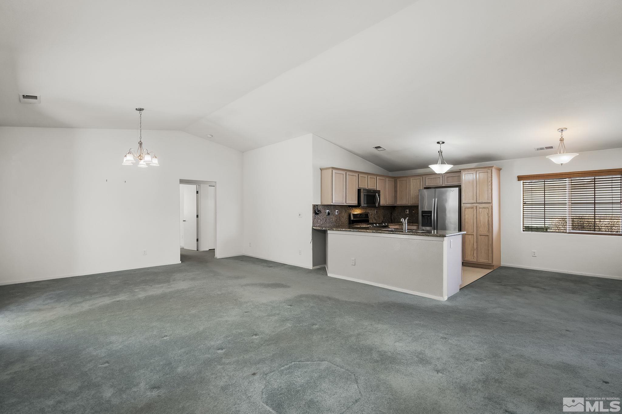 1095 Conifer Drive Minden, NV 89423 - Photo 3 of 19 a view of kitchen with refrigerator and white cabinets