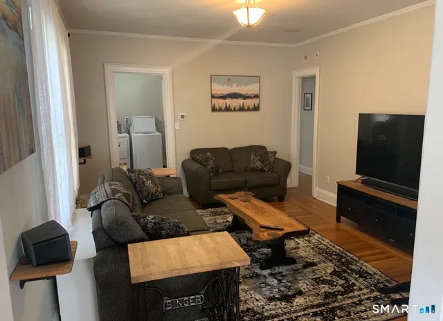 a living room with furniture and a flat screen tv
