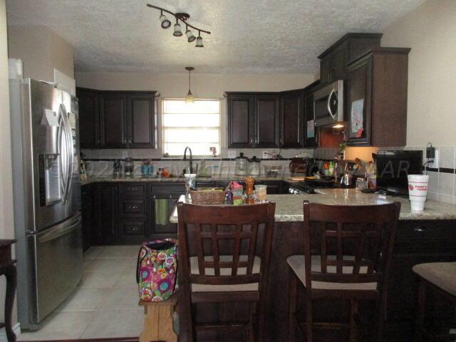 4243 Camp Lane Amarillo, TX 79110 - Photo 2 of 17 a kitchen with stainless steel appliances granite countertop a refrigerator stove a sink and dishwasher