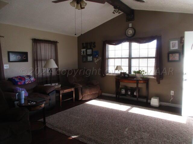4243 Camp Lane Amarillo, TX 79110 - Photo 3 of 17 a living room with furniture a chandelier and a window