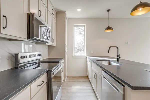 a kitchen with a sink and appliances